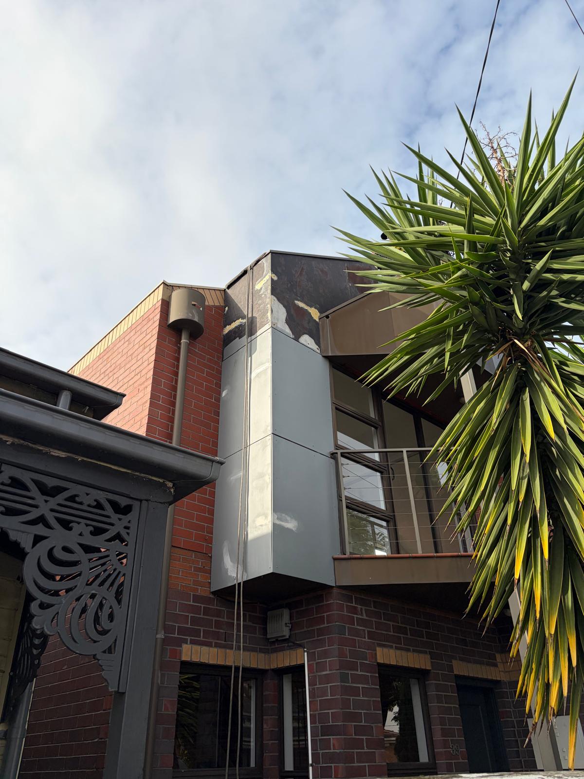 Building facade before rope access painting Melbourne — weathered and peeling paint